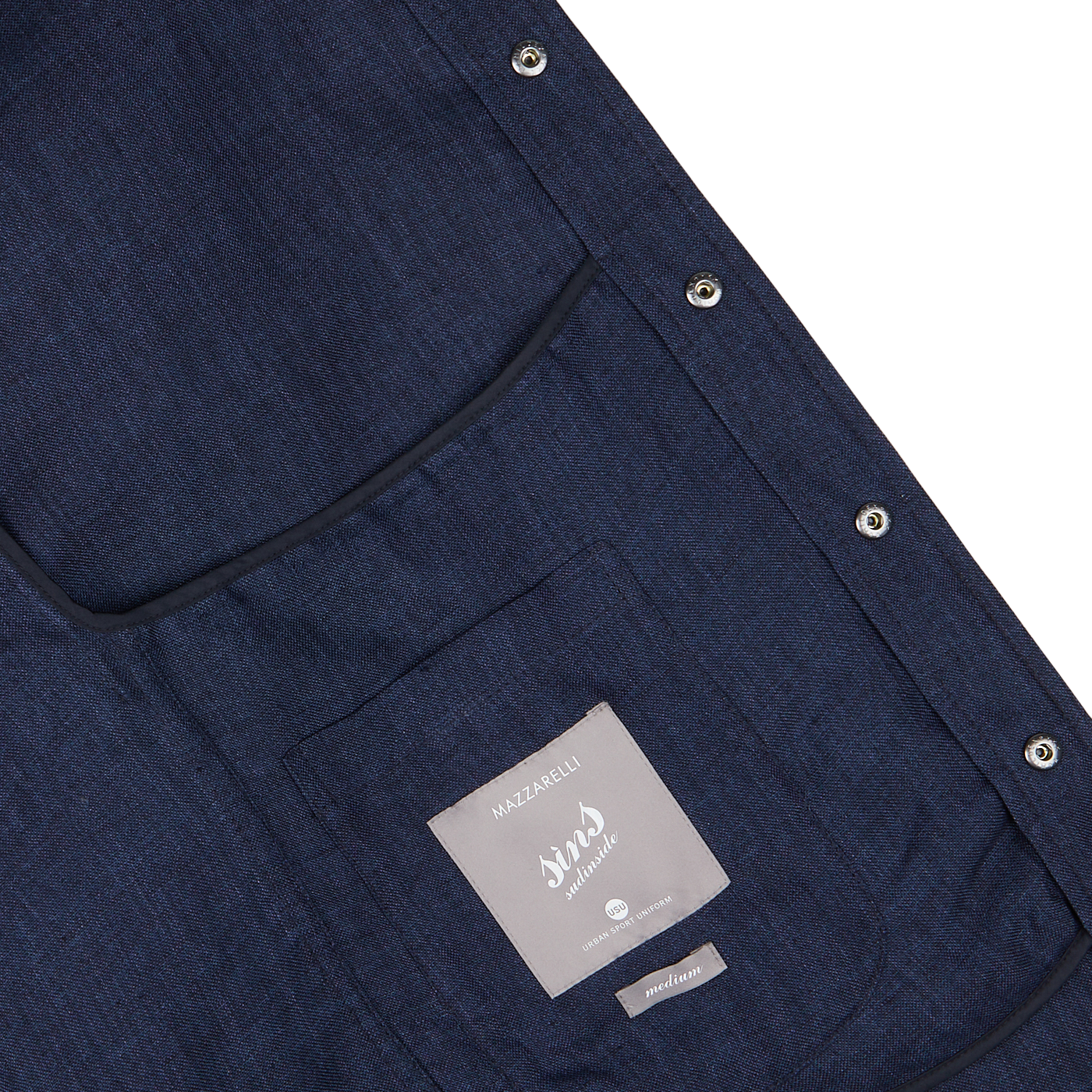 Close-up of a Mazzarelli dark blue organic linen overshirt detail showing a pocket and a label.