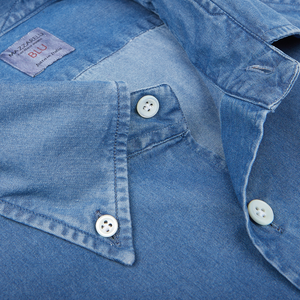 Close-up of a Mazzarelli dark denim washed cotton BD regular fit shirt with white buttons.