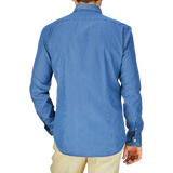 A person standing with their back to the camera, wearing a Dark Denim Washed Cotton BD Regular Fit Shirt by Mazzarelli and beige pants.