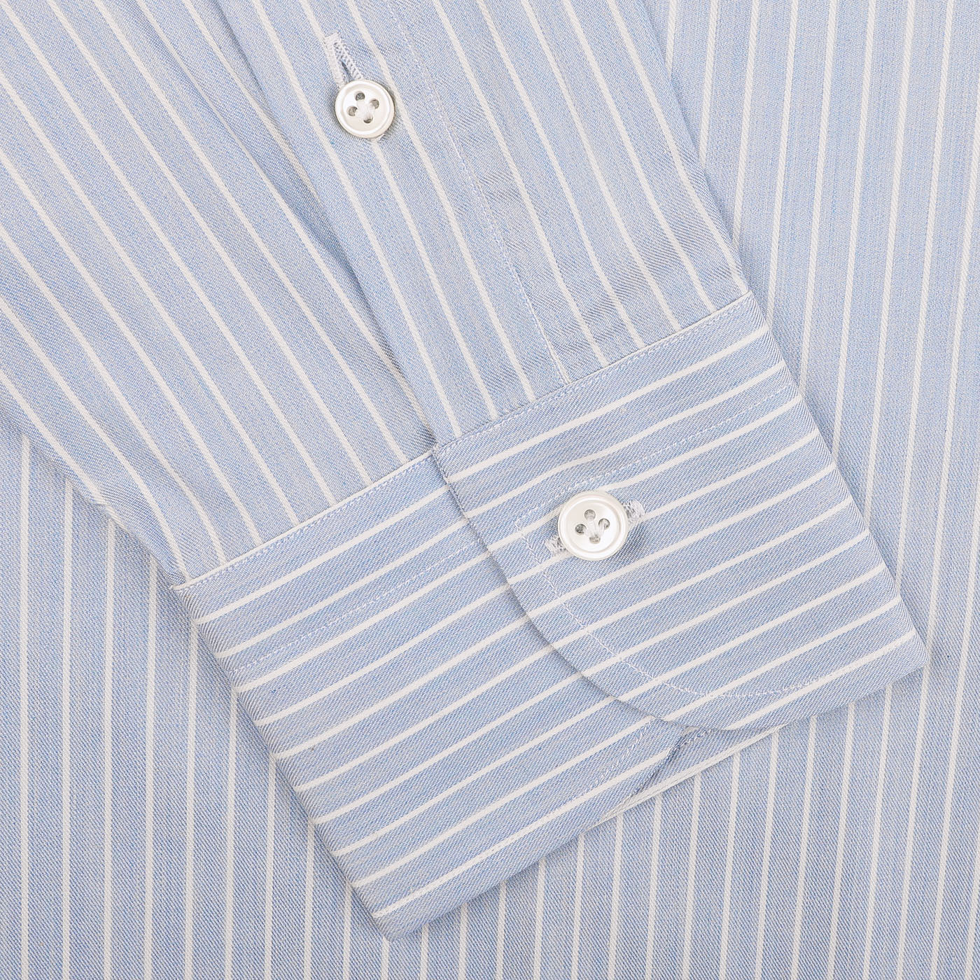 Close-up of the Denim Blue Striped Cotton BD Regular Shirt cuff by Mazzarelli, featuring two white buttons and a regular-fit design that exudes timeless elegance.