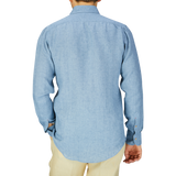 A person wearing a Denim Blue Washed Linen BD Slim Shirt by Mazzarelli viewed from the back.