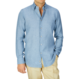 Man in a Mazzarelli Denim Blue Washed Linen BD Slim Shirt and beige pants.
