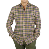 A man wearing a Green Checked Brushed Cotton Regular Shirt, reminiscent of Mazzarelli's impeccable craftsmanship.