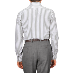 An individual is seen from the back, wearing a Green Vintage Wide-Striped Cotton BD Shirt made from organic cotton by the Italian brand Mazzarelli, paired with gray trousers.