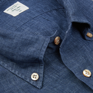 Close-up of a green stone collection Indigo Blue Organic Linen BD Slim Shirt with buttons and collar detail from Italian shirtmaker Mazzarelli.