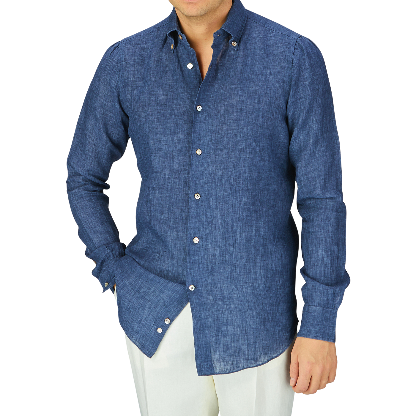 A man wearing an Indigo Blue Organic Linen BD Slim Shirt by Italian shirtmaker Mazzarelli and white pants.