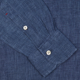 Close-up of a indigo blue organic linen BD slim shirt cuff with a white button by Italian shirtmaker Mazzarelli.
