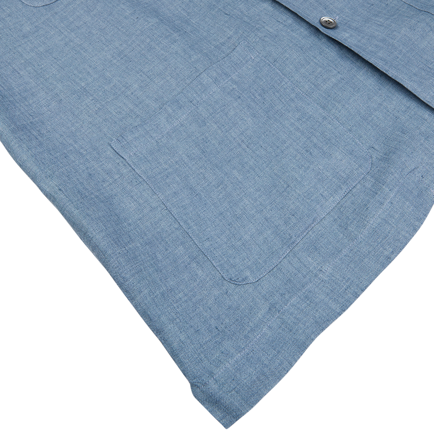 Mazzarelli Indigo blue denim shirt laid flat, detailed view of chest pocket and button.