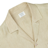 Close-up of a Khaki Beige Organic Linen Four Pocket Overshirt with a Mazzarelli brand label on the collar, highlighting the textured fabric and collar design.