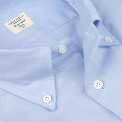 A close-up of the Light Blue Brushed Cotton Twill BD Slim Shirt reveals its three buttons, with a label that reads "Mazzarelli.