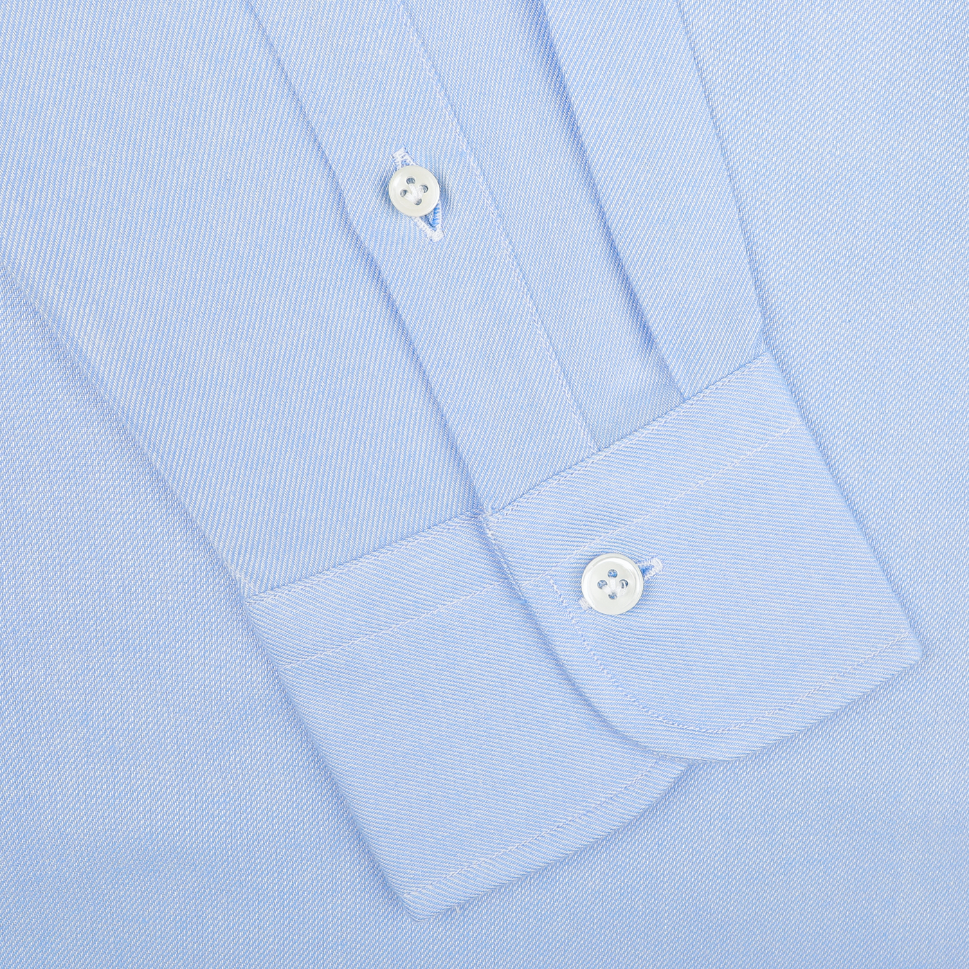 Close-up of the sleeve of the Mazzarelli Light Blue Brushed Cotton Twill BD Slim Shirt, featuring white buttons on a cuffed end with a stripe pattern, expertly laid flat.