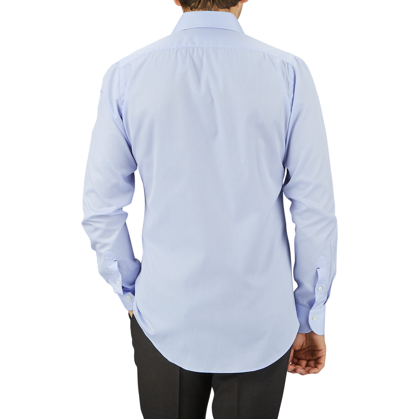 A man viewed from behind, wearing a Mazzarelli Light Blue Cotton Twill Cut Away Slim Shirt with a cutaway spread collar and dark trousers, standing against a neutral gray background.