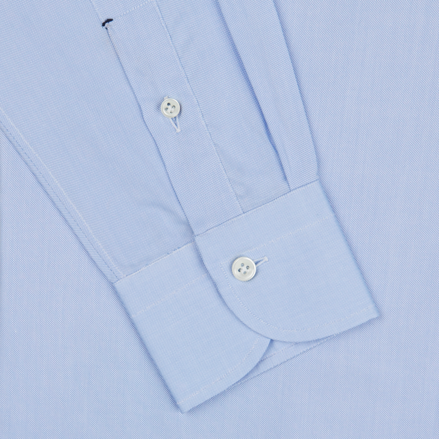 Close-up view of a Mazzarelli light blue royal oxford BD slim shirt showing detail of the cuff with two buttons and placket.