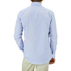 Man standing with his back to the camera wearing a Light Blue White Striped Cotton BD Slim Shirt by Mazzarelli and light green pants.