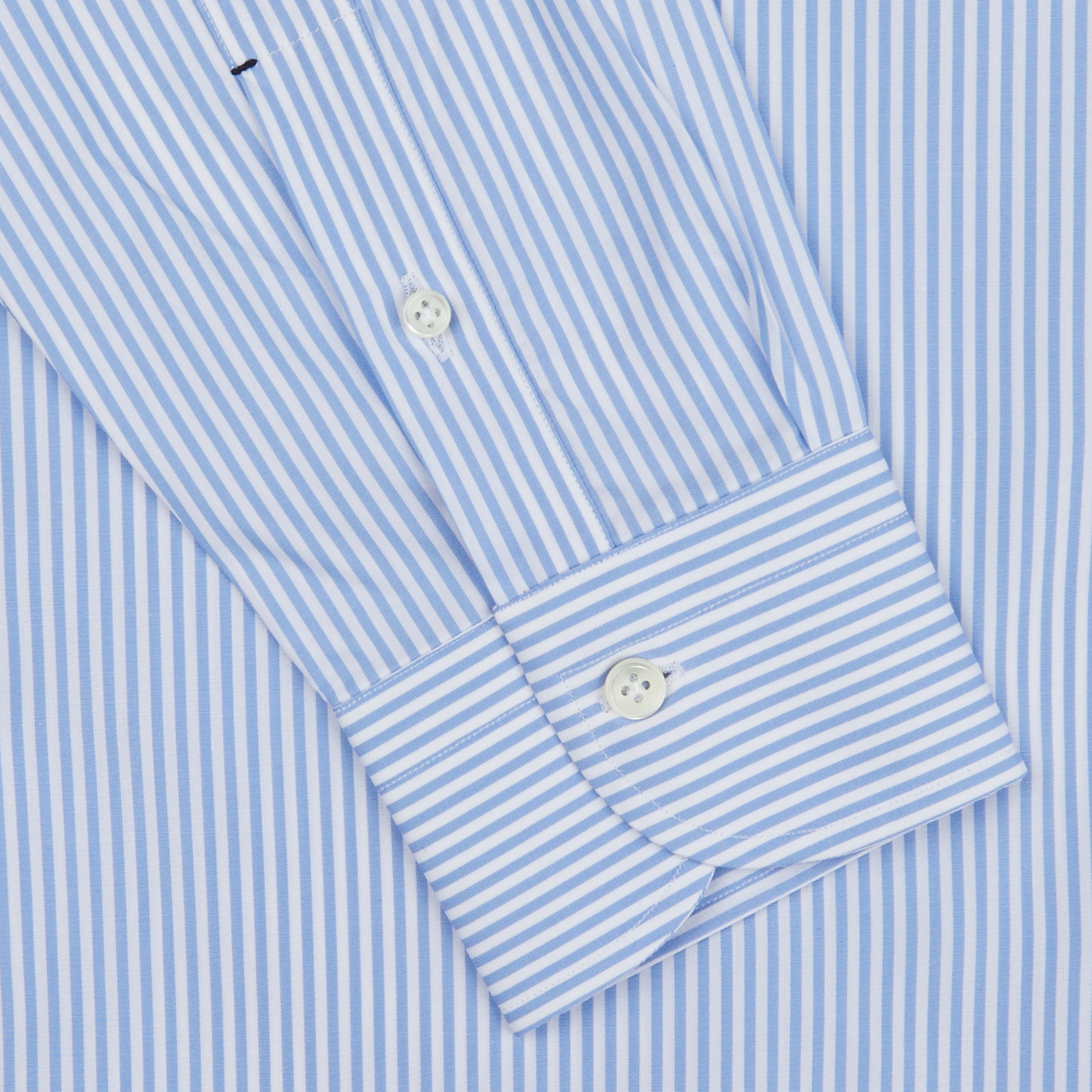 Close-up of a Mazzarelli Light Blue White Striped Cotton BD Slim Shirt showing detail of the cuff with buttons.