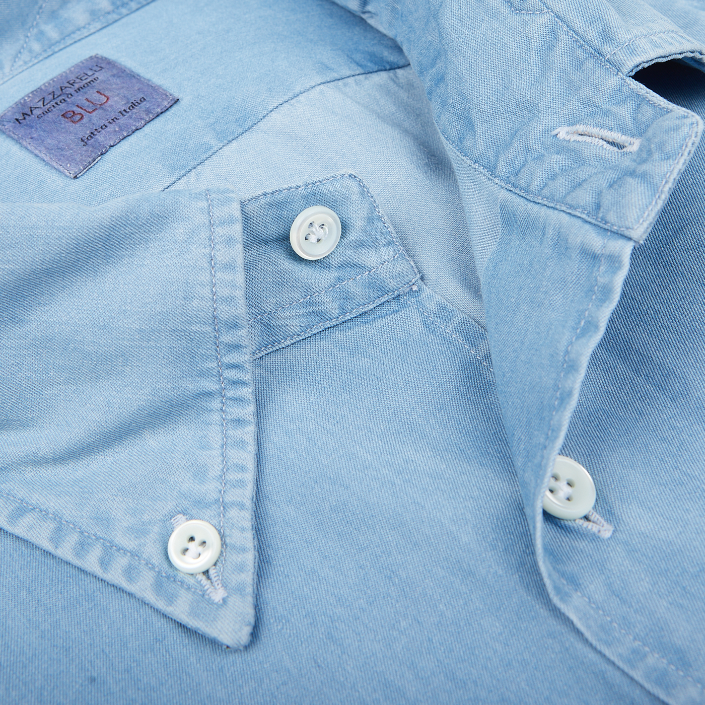 Close-up of a Light Denim Washed Cotton BD Regular Fit Shirt with white buttons from Italian shirtmaker Mazzarelli.