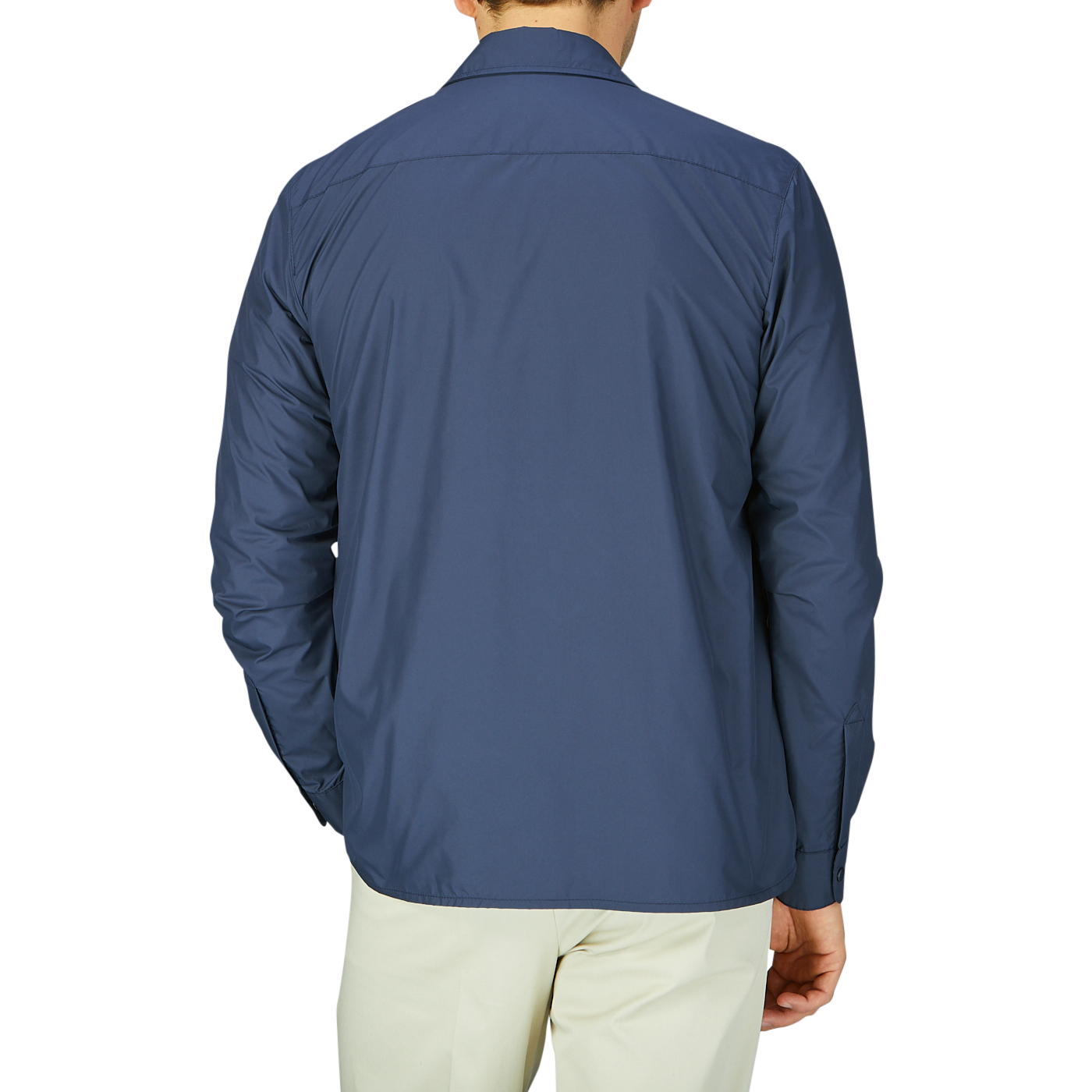 Man wearing a Mazzarelli navy blue nylon water resistant overshirt and light-colored pants from behind.