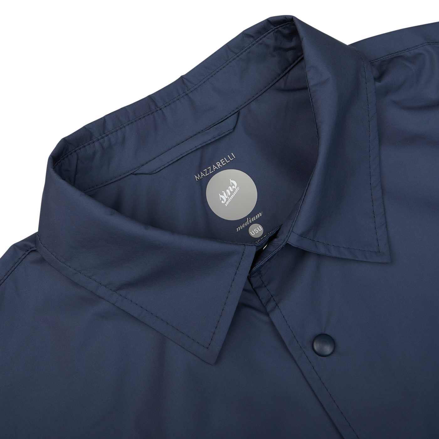 Navy blue nylon water resistant overshirt by Mazzarelli with brand label visible on the inside.
