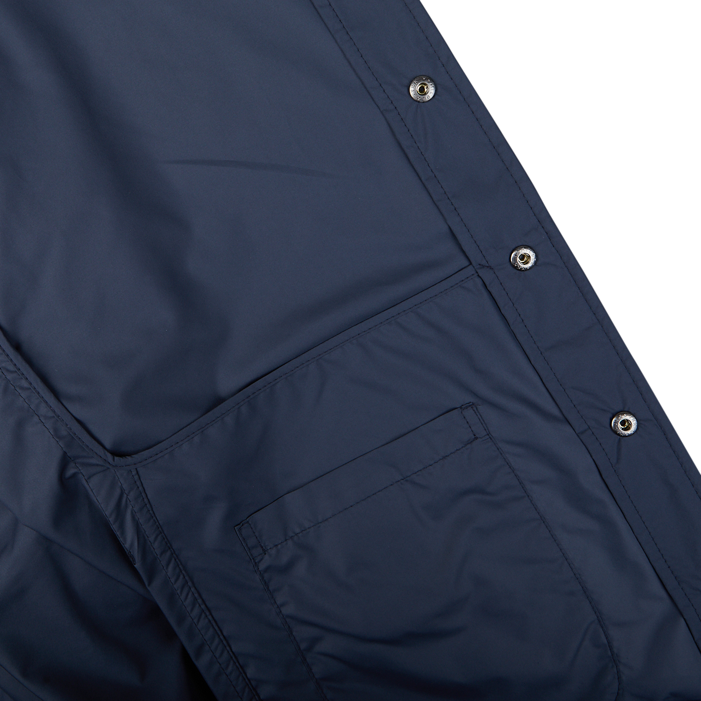 Close-up of a Mazzarelli navy blue nylon water resistant overshirt with pockets and snap buttons.