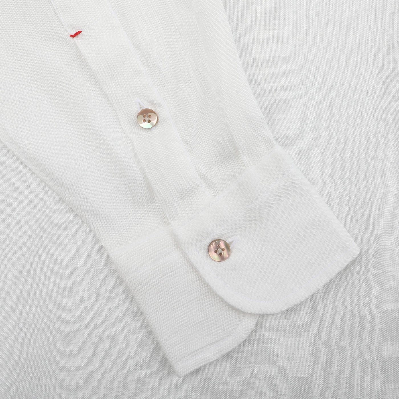 The Off-White Organic Linen BD Shirt by Mazzarelli boasts a button-down collar with two buttons and unique red stitching on a pristine white organic linen background.