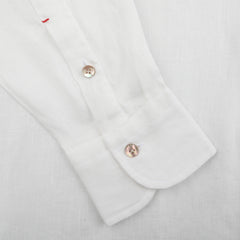 The Off-White Organic Linen BD Shirt by Mazzarelli boasts a button-down collar with two buttons and unique red stitching on a pristine white organic linen background.