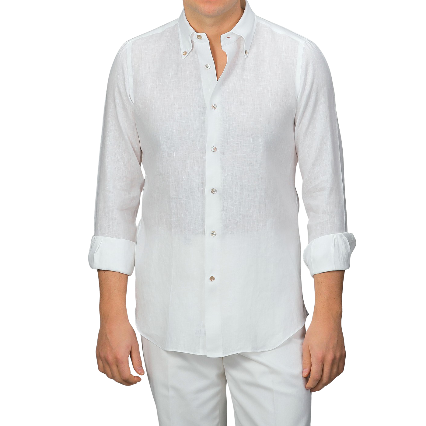 A person wearing an Off-White Organic Linen BD Shirt by Mazzarelli with rolled-up sleeves, paired with white pants.