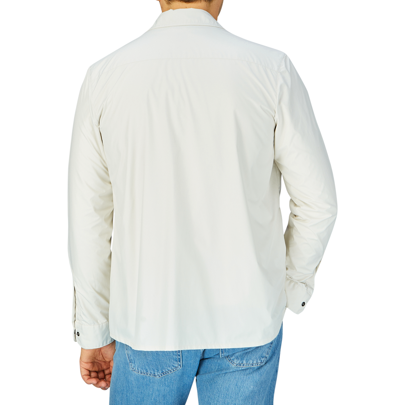 Man wearing a white shirt and blue jeans viewed from behind, covered by a slim fit Off-White Nylon Water Resistant Overshirt by Mazzarelli.