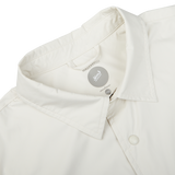 Close-up view of a beige Mazzarelli Off-White Nylon Water Resistant Overshirt collar displaying a brand label.