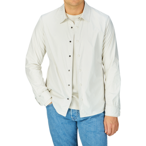 Man wearing a Mazzarelli water-resistant nylon, slim fit technical overshirt with white button-up shirt and blue jeans.
