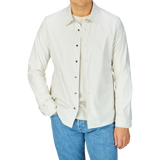 Man wearing a Mazzarelli water-resistant nylon, slim fit technical overshirt with white button-up shirt and blue jeans.