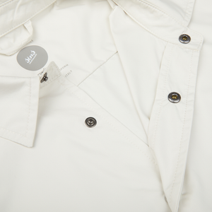 Close-up of a slim fit Off-White Nylon Water Resistant Overshirt by Mazzarelli with a designer label and black buttons.