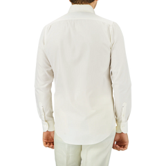 Back view of a person wearing an Off White Cotton Twill BD Slim Shirt by Mazzarelli and light-colored pants.