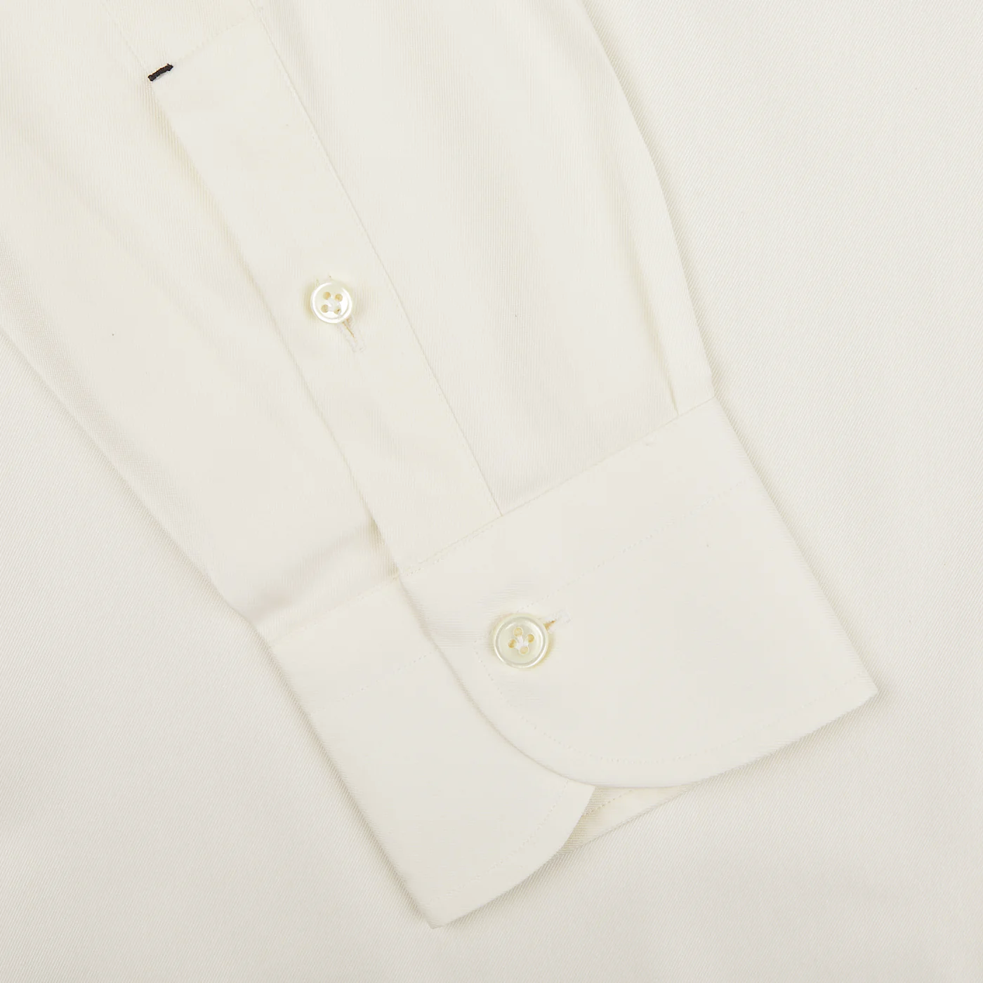 A detailed view of the sleeve from the Mazzarelli Off White Cotton Twill BD Slim Shirt, showcasing buttoned cuffs against a plain background, crafted from pure cotton twill.