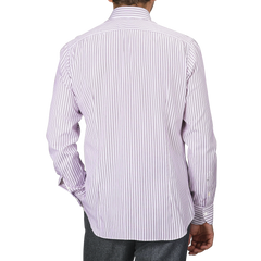 The individual is wearing a Purple Double Striped Cotton BD Regular Shirt by Mazzarelli, showcasing a long-sleeved white and purple striped design with a soft button-down collar and hand-stitched pleated shoulder, elegantly seen from the back.