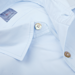 Close-up of a Mazzarelli Sky Blue Cotton Gabardine Regular Fit Shirt with a focus on the collar and button.