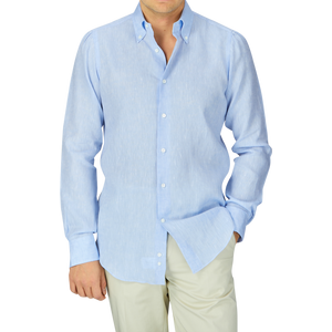 Man wearing a Mazzarelli Sky Blue Organic Linen BD Slim Shirt and beige trousers.