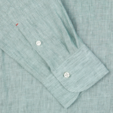 Close-up of a Mazzarelli Teal Green Organic Linen BD Slim Shirt's cuff with two white buttons.