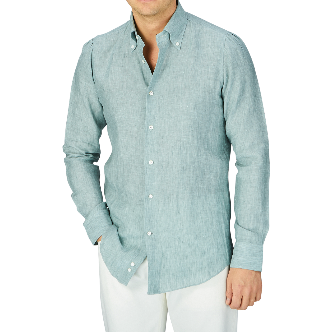 A person wearing a teal green organic linen BD slim shirt from the Italian shirtmaker Mazzarelli and white trousers.