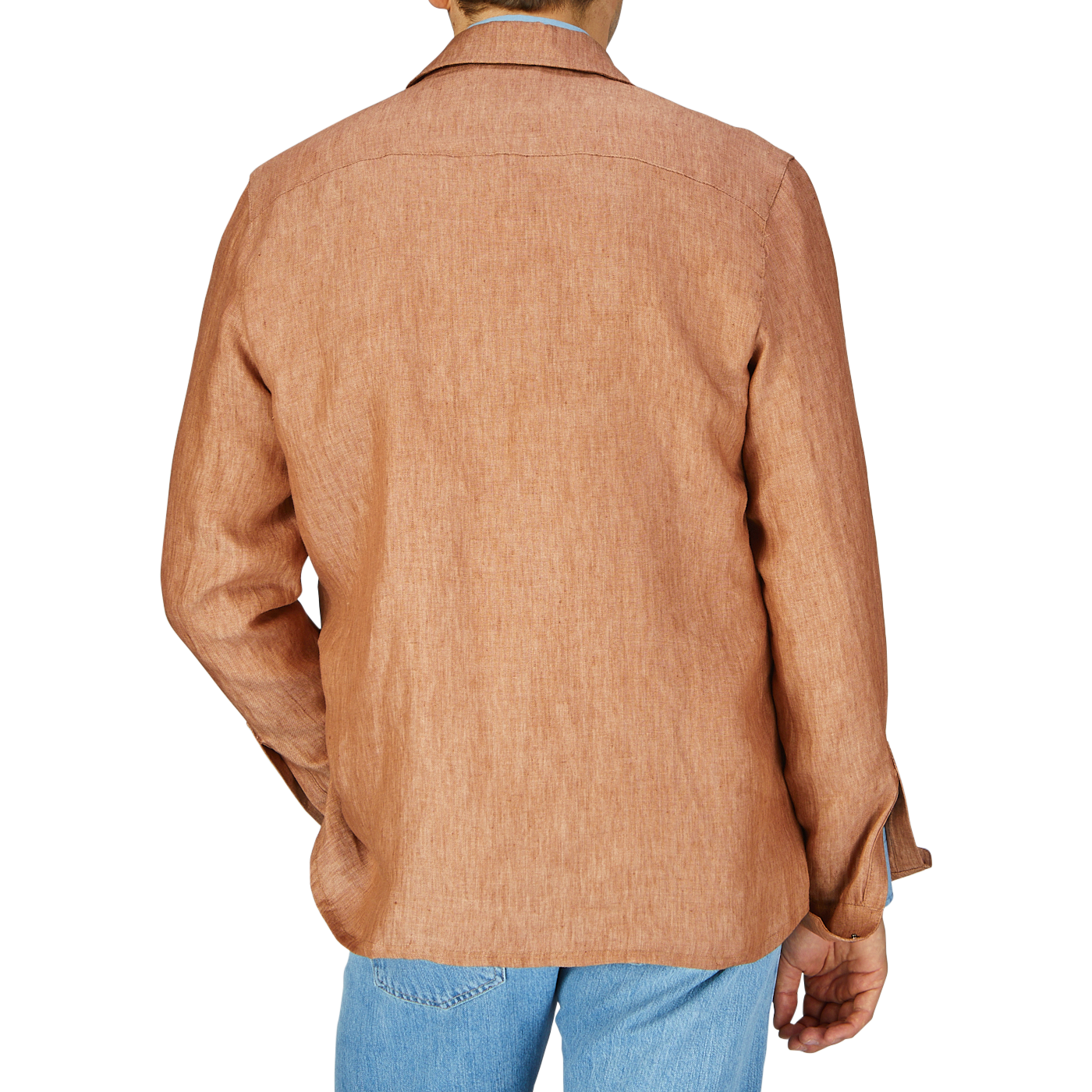 Rear view of a person wearing a terracotta brown Mazzarelli organic linen overshirt and blue jeans.