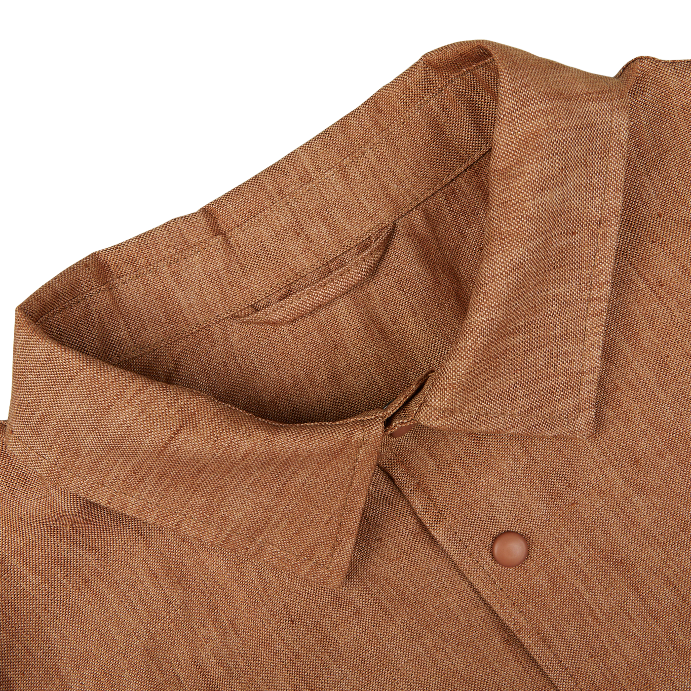 Close-up view of a Mazzarelli terracotta brown organic linen overshirt with a focus on the collar and button detail.