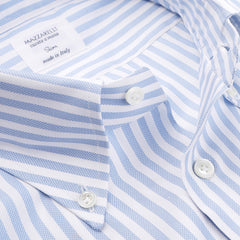 Close-up of the White Blue Bengal Striped BD Slim Shirt by Mazzarelli, crafted from pinpoint cotton with white buttons and a tag reading "Mazzarelli, Cucitoto a Mano, Slim, made in Italy." The hand-stitched pleated shoulder adds an additional touch of elegance.