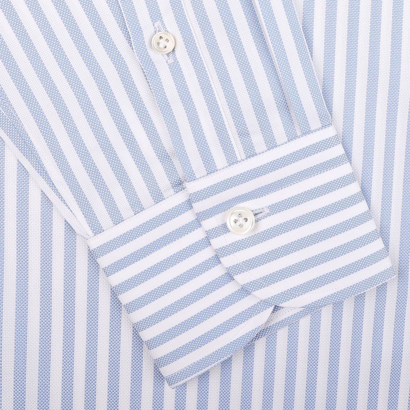 Close-up of a cuff from the Mazzarelli White Blue Bengal Striped BD Slim Shirt, crafted with luxurious pinpoint cotton and adorned with two pristine white buttons.