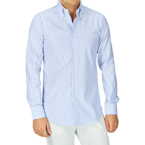 A person wearing a White Blue Bengal Striped BD Slim Shirt by Mazzarelli with a soft button-down collar and white pants.