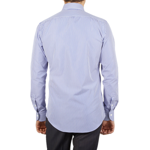 The back view of a slim man wearing a Mazzarelli White Blue Striped Cotton BD Slim Shirt.