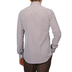 A person in a White Brown Striped Cotton BD Slim Shirt by Mazzarelli, featuring a button-down collar, faces away from the camera.