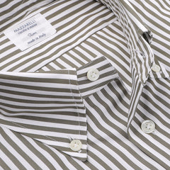 A close-up of a seasonal shirt by the renowned Italian brand Mazzarelli highlights the pure cotton fabric. The button-up design boasts elegant alternating white and green stripes, accompanied by a label that reads "Made in Italy.