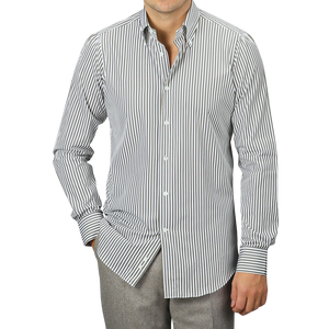 A man dressed in a White Green Striped Cotton BD Slim Shirt by Mazzarelli, styled with gray pants and one hand in his pocket.