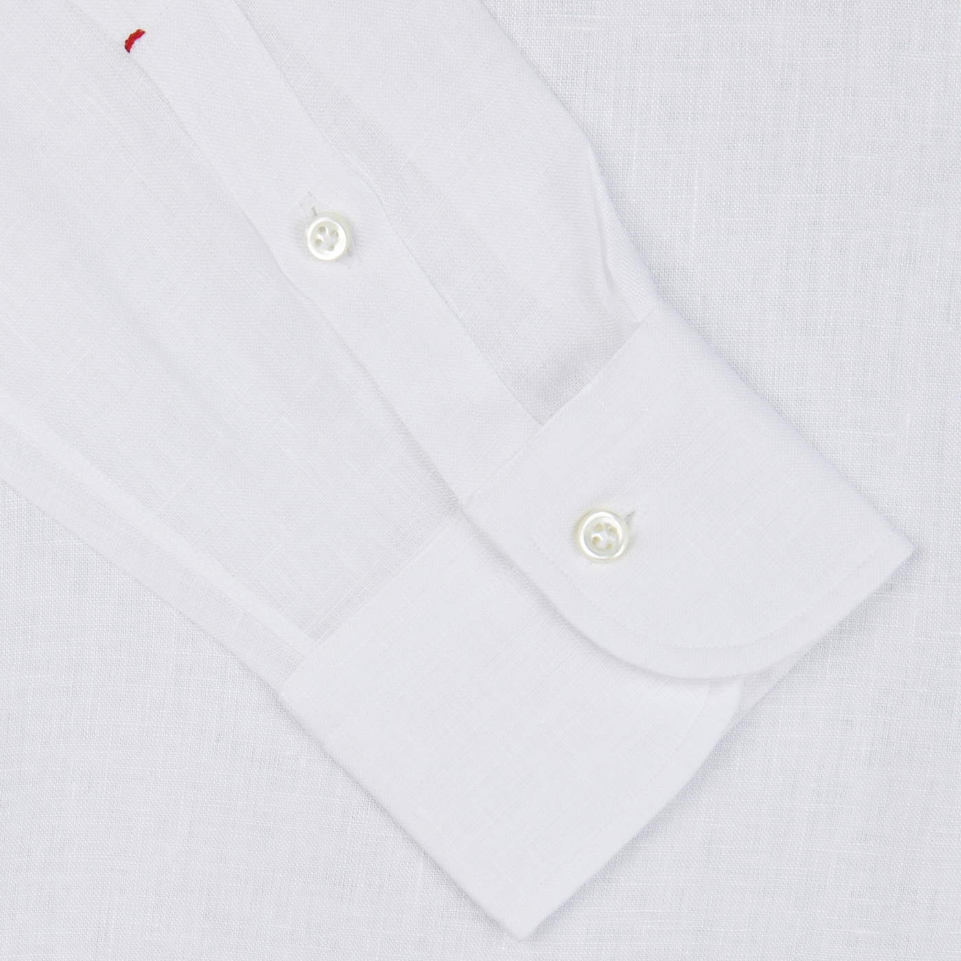 Close-up of an Italian shirtmaker Mazzarelli White Organic Linen BD Slim Shirt cuff with buttons.