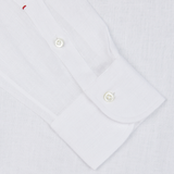 Close-up of an Italian shirtmaker Mazzarelli White Organic Linen BD Slim Shirt cuff with buttons.