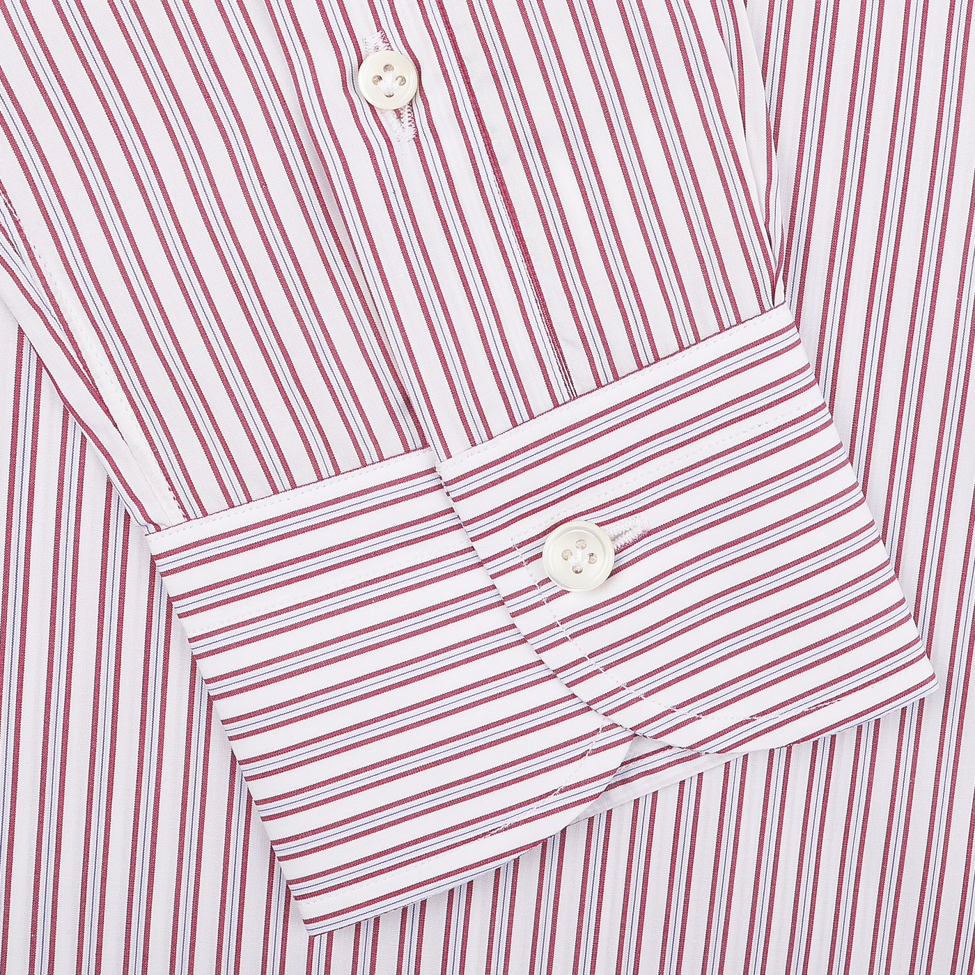 Close-up of the Mazzarelli White Red Vintage Striped Cotton BD Slim Shirt, exquisitely crafted from cotton twill. The sleeve is adorned with elegant white buttons on the cuff, highlighting the impeccable craftsmanship of this Italian shirtmaker.